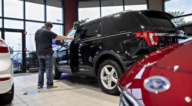 A customer looks over a Ford 2020 Explorer