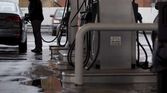 A customer refuels his vehicle at a Hess Corp. gas station in Washington, D.C.