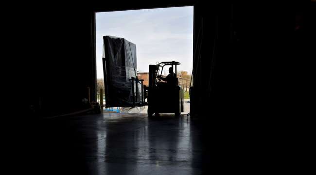 A worker uses a forklift to move packages at a facility in Baltimore.