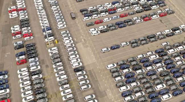 Recently assembled vehicles are stored in the distribution yard at the closed Vauxhall car factory in England on March 17.
