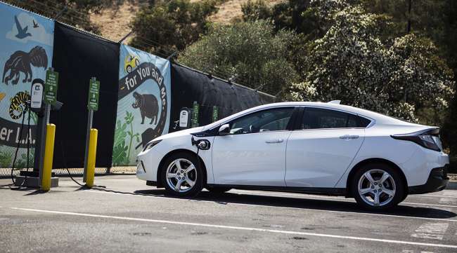 A ClipperCreek Inc. charging plug is connected to a GM Chevrolet Volt electric vehicle at a charging station in Los Angeles