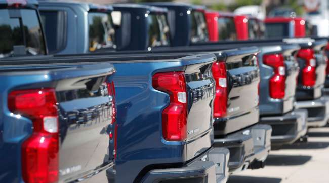 A row of 2019 Chevrolet Silverado pickup trucks sit at a dealership in Colorado in July 2019.