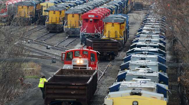 A crew works near locomotives stored at the Wabtec Corp. location in Lawrence Park Township, Pa.