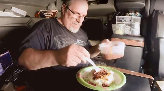 Trucker eating meal in cab
