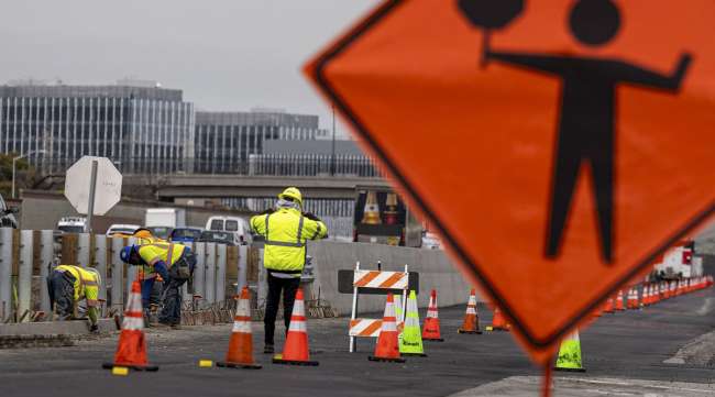 Contractors work on a road along Highway 101 in San Mateo, Calif. (David Paul Morris/Bloomberg News)
