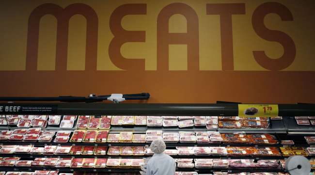 A Kroger employee restocks meat at a store location in Kentucky in March 2019.