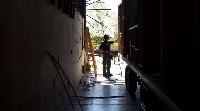 A worker installs plumbing at a manufacturing facility in Elkhart, Indiana. (Ty Wright/Bloomberg News)