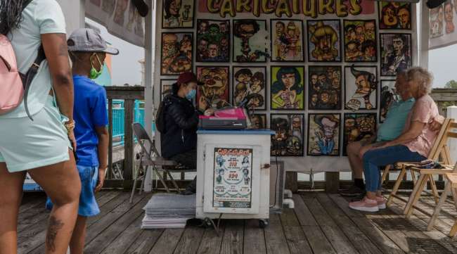 A caricature artist draws the image of a couple in Myrtle Beach, S.C. (Micah Green/Bloomberg News)