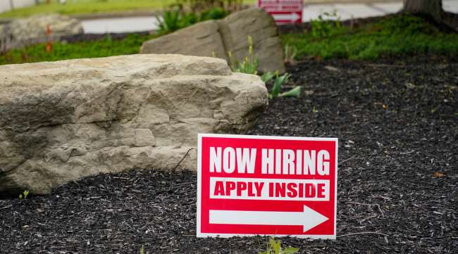 Hiring signs sit outside a gas station in Pennsylvania. (Keith Srakocic/Associated Press)