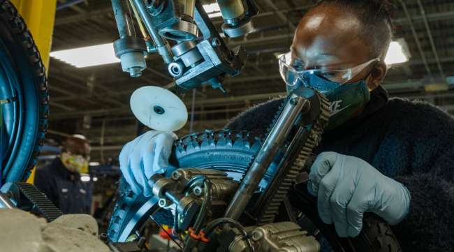 An employee inspects a tire at a bicycle production facility in Manning, S.C. (Micah Green/Bloomberg News)