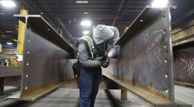 A worker inspects structural beams at a facility in Utah. (George Frey/Bloomberg News)