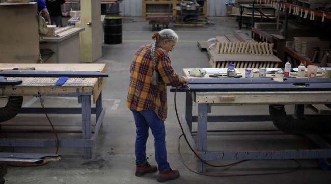 A worker sands wood components for a pool table in Jeffersonville, Ind. (Luke Sharrett/Bloomberg News)