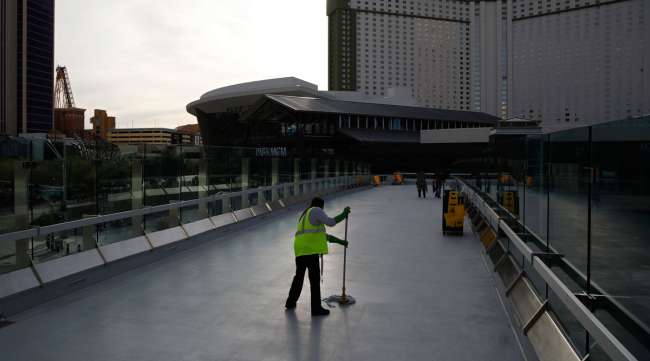 A worker cleans along the Las Vegas Strip in March 2020. (John Locher/Associated Press)