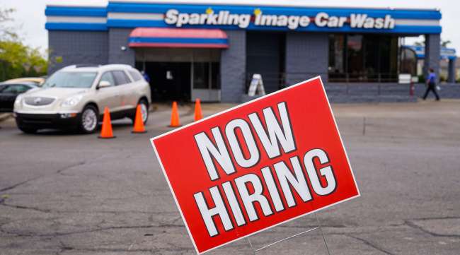 A help wanted sign is displayed outside a car wash in Indianapolis.