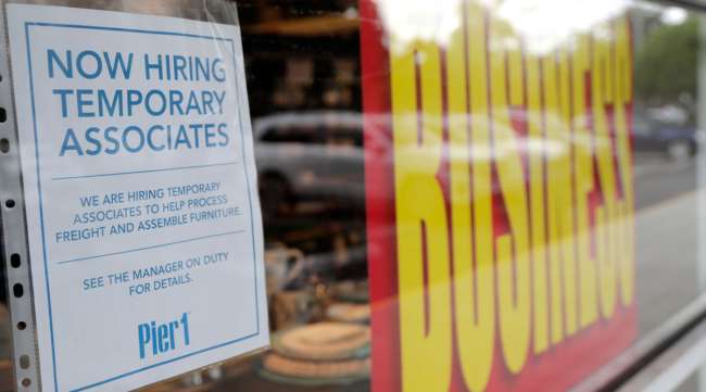 A sign advertises hiring of temporary associates at a Pier 1 store in Florida.