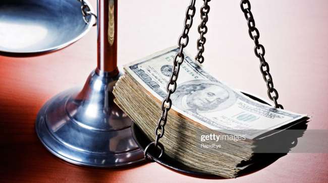 scales of justice with cash