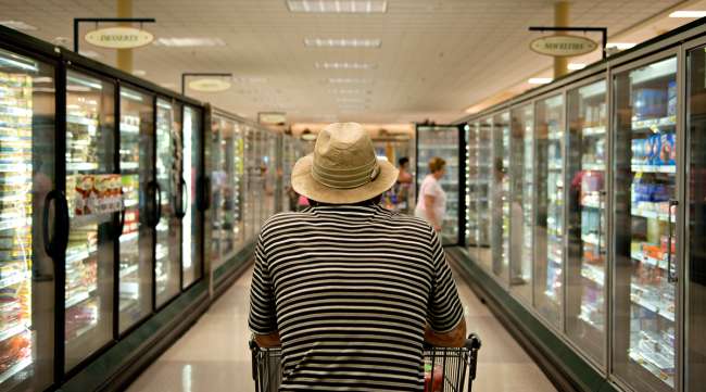 A shopper pushes a cart in a Kroger supermarket