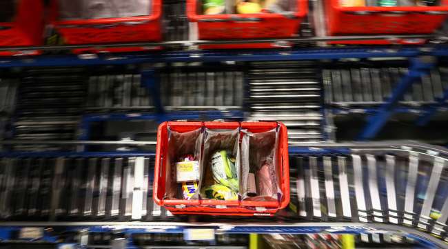 A customer order crate travels along a conveyor belt at the Ocado Group Plc distribution center in the United Kingdom.