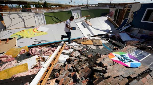 Benjamin Luna helps recover items from an Orange, Texas, church destroyed by Hurricane Laura.