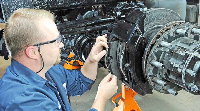 Technician installs brake pads