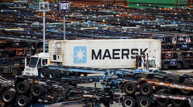 A Maersk truck transports a shipping container