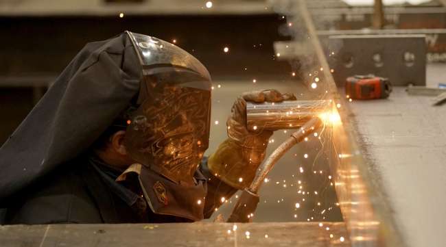 A worker welds a structural steel beam during production at a facility in Utah. (George Frey/Bloomberg News)