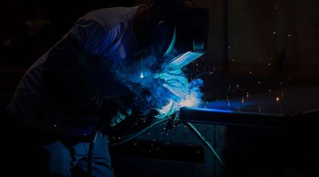 A worker welds parts for a ballot drop box inside a manufacturing facility in Washington.