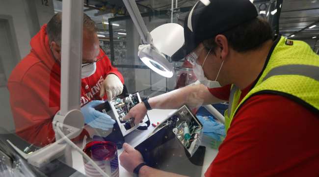 Ford employees work on a ventilator at a plant in Michigan on May 13.