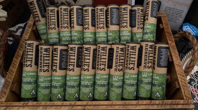 A display of pre-rolled marijuana cigarettes from Willie's Reserve at a section in a farmers market during a business-to-business networking event, WeedCon West 2019, in Los Angeles