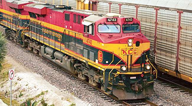 A Kansas City Southern train passes an automotive train in Mexico