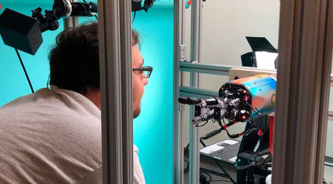 OpenAI researcher Jonas Schneider examines the research lab’s robotic hand