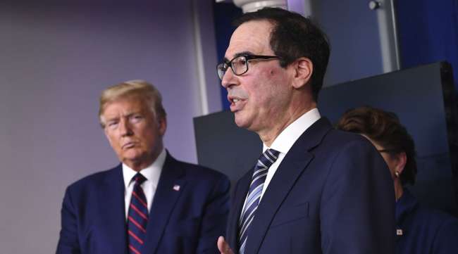 U.S. Treasury Secretary Steve Mnuchin speaks during a Coronavirus Task Force news conference at the White House on April 2 with President Trump in the background.