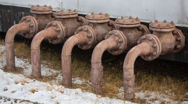 Crude oil pipework is seen in an oilfield in Russia.