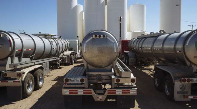 Tanker trucks sit in front of storage silos in Sunray, Texas, on Sept. 26. (Angus Mordant/Bloomberg News)