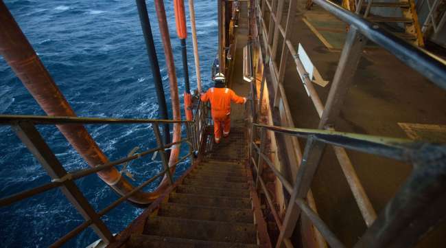 An employee walks down stairs at the Armada gas condensate platform.