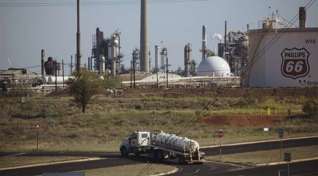 A tanker truck drives past a Phillips 66 refinery in Borger, Texas.