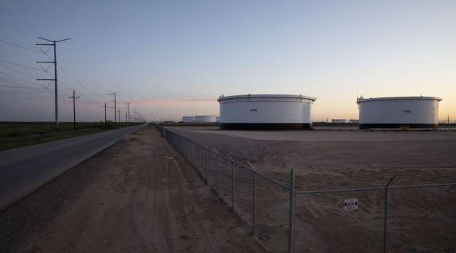 Crude oil storage tanks stand outside Midland, Texas, on April 24.