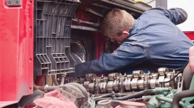 A technician repairs a Class 8 truck