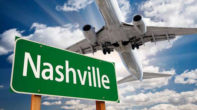 Plane flying over Nashville sign