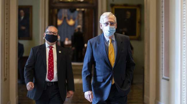 Senate Majority Leader Mitch McConnell walks to his office at the U.S. Capitol on May 21.