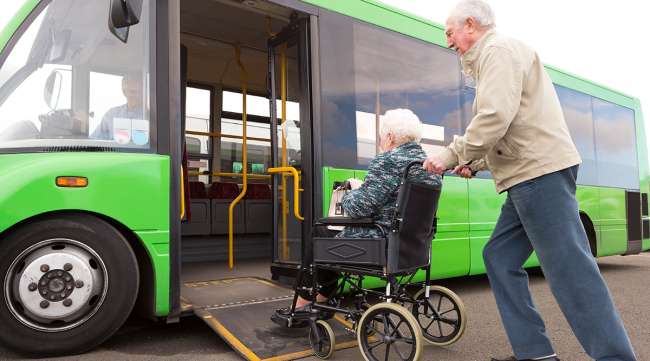Older couple getting on bus