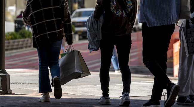 Pedestrians carry shopping bags on Powell Street in San Francisco.