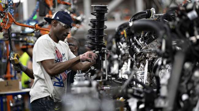 A worker assembles a vehicle component at the Ford Motor Co. Chicago Assembly Plant. (Daniel Acker/Bloomberg News)