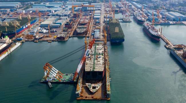 Ships sit under construction at a shipyard in South Korea in June. (SeongJoon Cho/Bloomberg News)