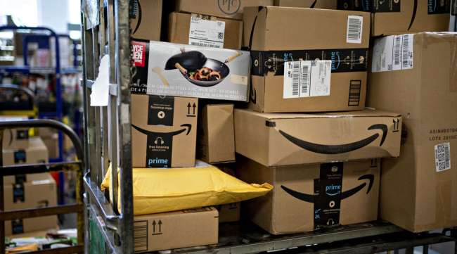 Amazon boxes sit at a USPS facility in Fairfax, Va., in May. (Andrew Harrer/Bloomberg News)
