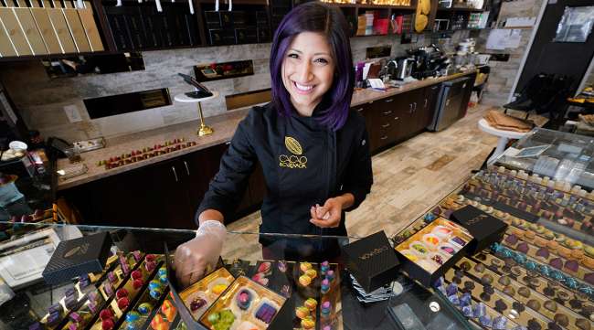 Businesswoman poses in her chocolate shop