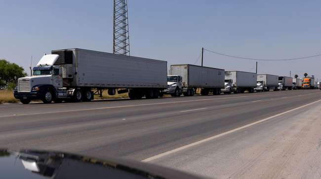 Commercial vehicles wait to pass into Mexico at the border crossing in Progreso, Texas.