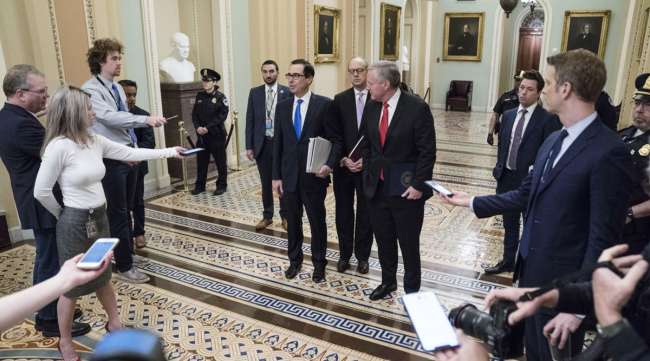 U.S. Treasury Secretary Steve Mnuchin (blue tie) and White House Chief of Staff Mark Meadows (red tie) speak to media in the U.S. Capitol on March 24.