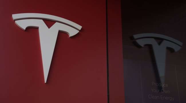 The Tesla logo is seen at a showroom in San Diego.