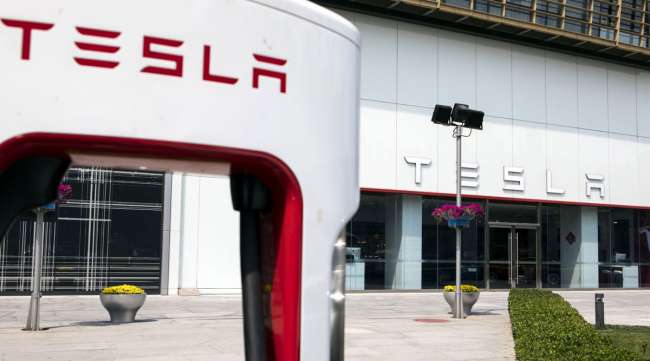 The Tesla logo is seen outside one of the company's showrooms in Beijing, China.